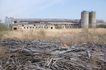Abandoned farm with ruins of wooden building
