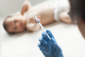 Young, female doctor giving an injection. 