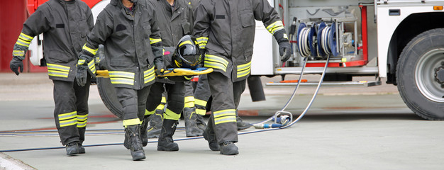 Naklejka premium firefighters carry an injured person