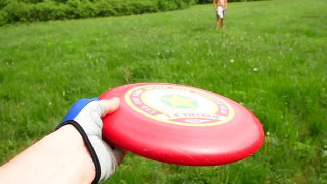 Two friends playing in frisbee in the clearing