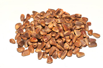 Pine nuts. Handful of pine nuts on a white background