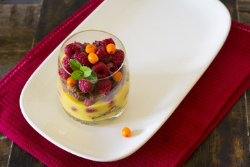 Raspberry dessert trifle. Dessert in glass. Mousse in glass. Orange curd. Chocolate sponge cake. Layered dessert. Cake in glass. Mini cake. Citrus dessert.