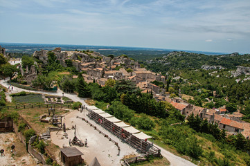 Fototapeta na wymiar Panoramic view of the Baux-de-Provence castle ruins on the hill, with the roofs of the village just below. Bouches-du-Rhone department, Provence-Alpes-Côte d'Azur region, southeastern France