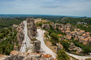 Panoramic view of the Baux-de-Provence castle ruins on the hill, with the roofs of the village just below. Vaucluse department, Provence-Alpes-Côte d'Azur region, southeastern France