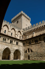 Fototapeta premium View of courtyard and internal buildings of the Palace of the Popes of Avignon, under a sunny blue sky. Located in the Vaucluse department, Provence-Alpes-Côte d'Azur region, southeastern France