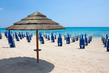 Straw umbrella from the sun on the beach