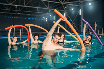 Instructor and class on workout in swimming pool