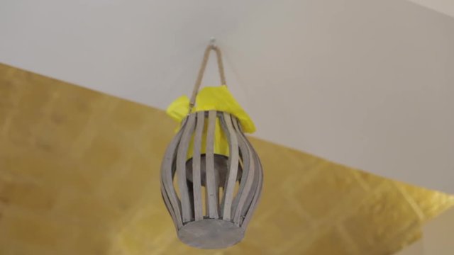 Wooden decoration hangs from ceiling, low angle