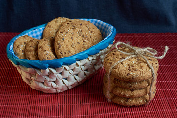 Savory cookies sprinkled with sesame seeds, sunflower on red table