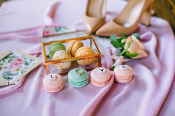 Macarones tasty french dessert on a pink background