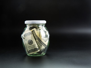 Money saving concept, glass jar full of dollars © Nomad_Soul