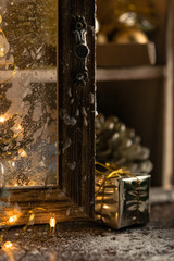 Winter holiday background: Christmas prezent mini golden box in the snow. Close up Small concept of handmade gift.