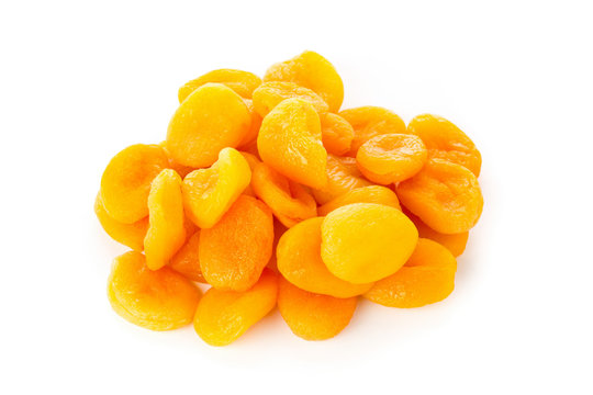 Heap of dried apricots fruit over white