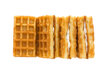 Soft waffles with a filling. Several waffles with a cream filling on a white background. Top view.