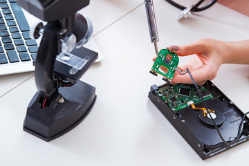 Engineer fixing broken computer hard drive