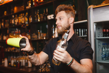 Professional bartender makes a show with a shaker