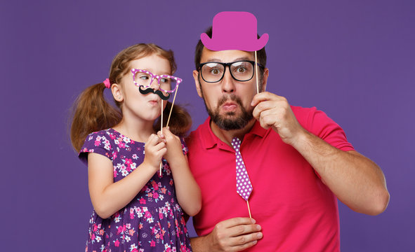happy father's day! funny dad and daughter with mustache fooling around on purple background