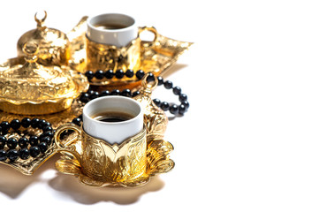 Obraz na płótnie Canvas Coffee cups rosary beads white background Islamic holidays Ramadan