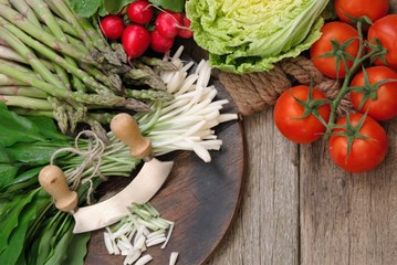 Allium ursinum , Ramson or wild garlic leaves on old wooden table. Top view. 