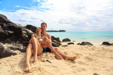 Romantic beautiful couple lying on the beach on the beautiful island of Seychelles