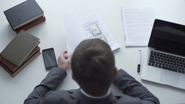 Businessman signing contract after taking bribe, raw deal, corrupt official