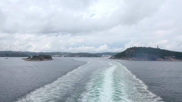 Ship Sails from the Coast of Norway to Denmark leaving Water Wake Behind. 4K Ultra HD