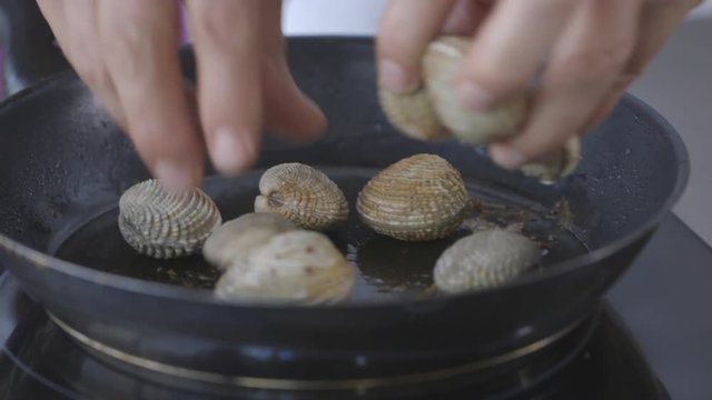 Close up, cooking clams on pan