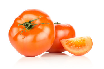 Two red tomato with one slice isolated on white background.