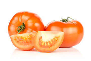 Two red tomatoes and two slices isolated on white background fresh.