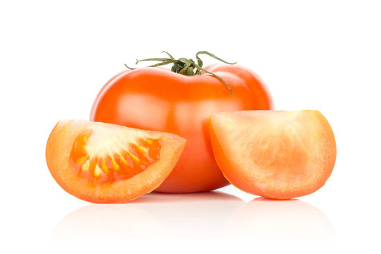 Red tomato and two slices isolated on white background.