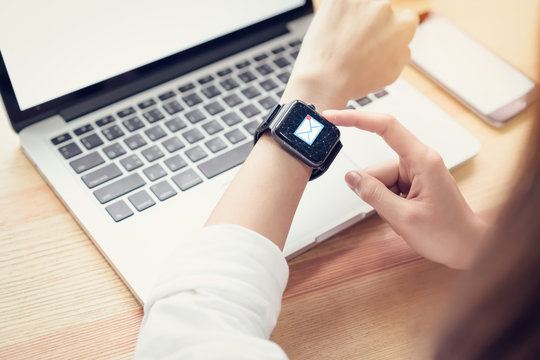 Business woman using smart watch show icon social email, Concept of communication and working online.