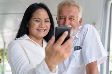 Obraz premium Mature multi-ethnic couple happy and in love while exploring the