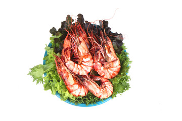 Grilled large fresh prawns  served with megetables on blue plate.