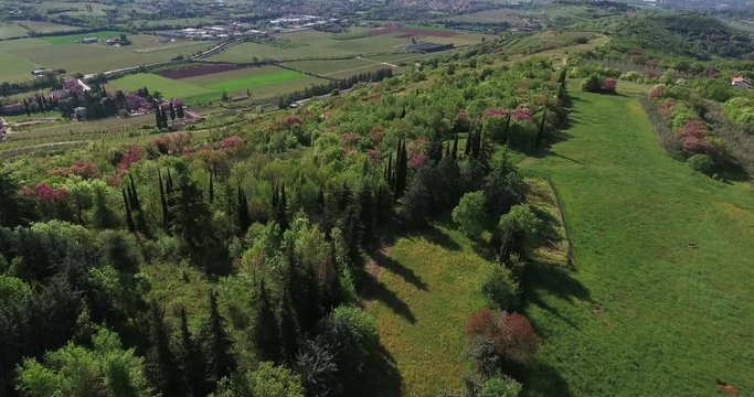 Tilt up aerial, scenic field in Verona