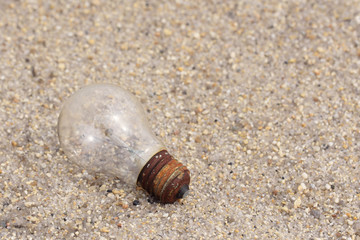 electric light bulb on sand