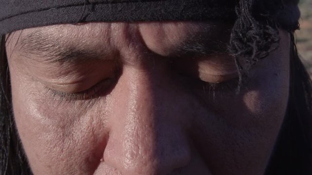 Native American Man opening his eyes and worried