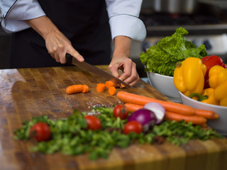 chef hands cutting carrots