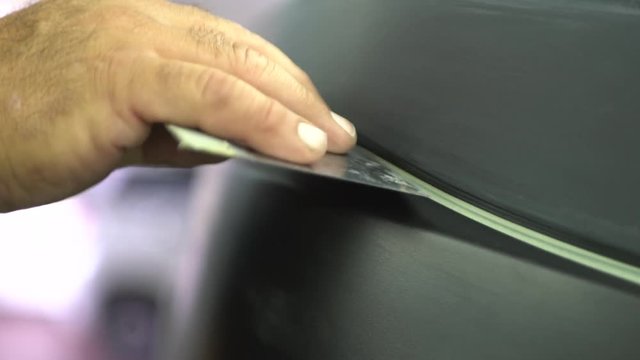 Person Uses Automotive Masking Tape On Car, Close Up