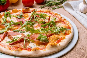 Pizza with Parma ham and arugula