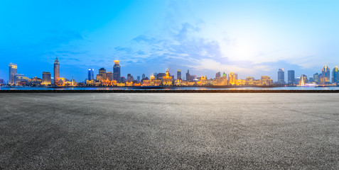 empty asphalt road and historic building panorama at sunset in Shanghai