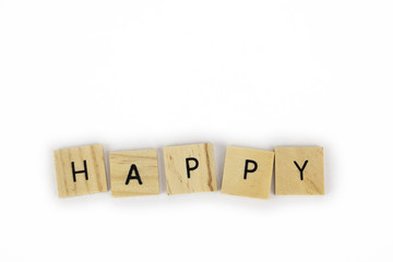 Wooden tiles spelling out the word happy on an isolated white background. Inspirational and motivational! 