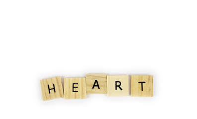 Wooden tiles spelling out the word heart on an isolated white background. Inspirational and motivational!  Room for text! 