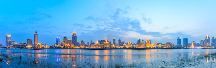 panoramic view of shanghai historic buildings at night in huangpu river