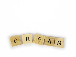 Wooden tiles spelling out the word dream on an isolated white background. Inspirational and motivational! 