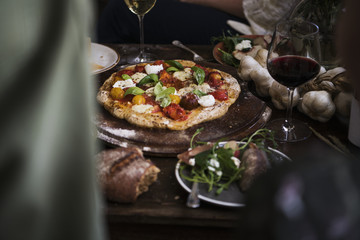 Homemade pizza for dinner with red wine