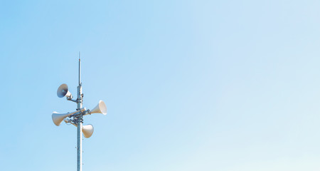 Fototapeta na wymiar Outdoor loudspeaker alert system against a blue sky
