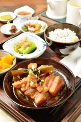 A set menu  stew pork with salad, rice and soup .