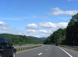 curving highway with tree covered hills