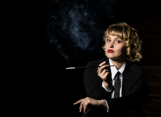 Obraz premium businesswoman with cigarette on a dark background, stylized retro portrait