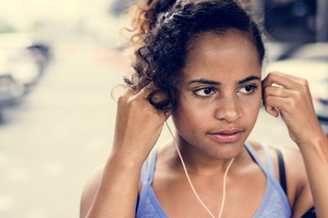 Healthy woman exercising while using technology